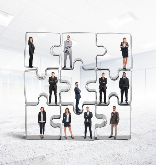 People stood within jigsaw pieces